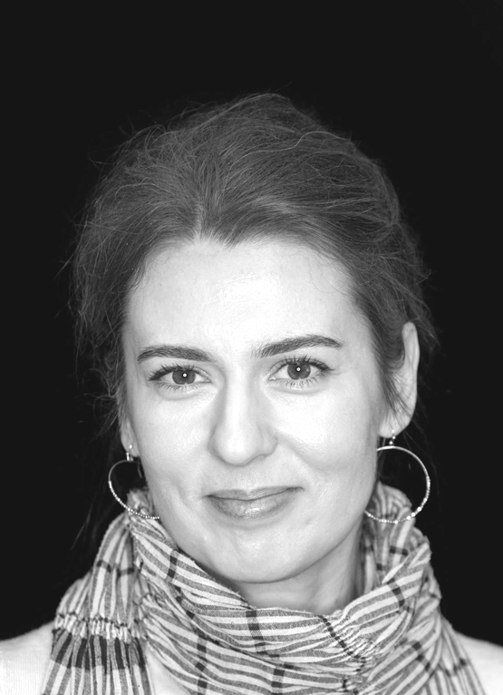 This is a grayscale portrait of Dr. Nikolic. She is smiling towards the camera against a dark background