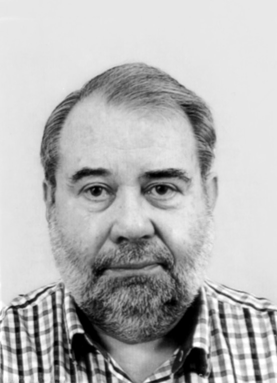 This is a grayscale portrait of Dr. Gielingh. He is wearing a checkered shirt against a light background.